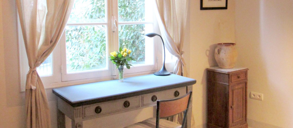 (desk at window)
